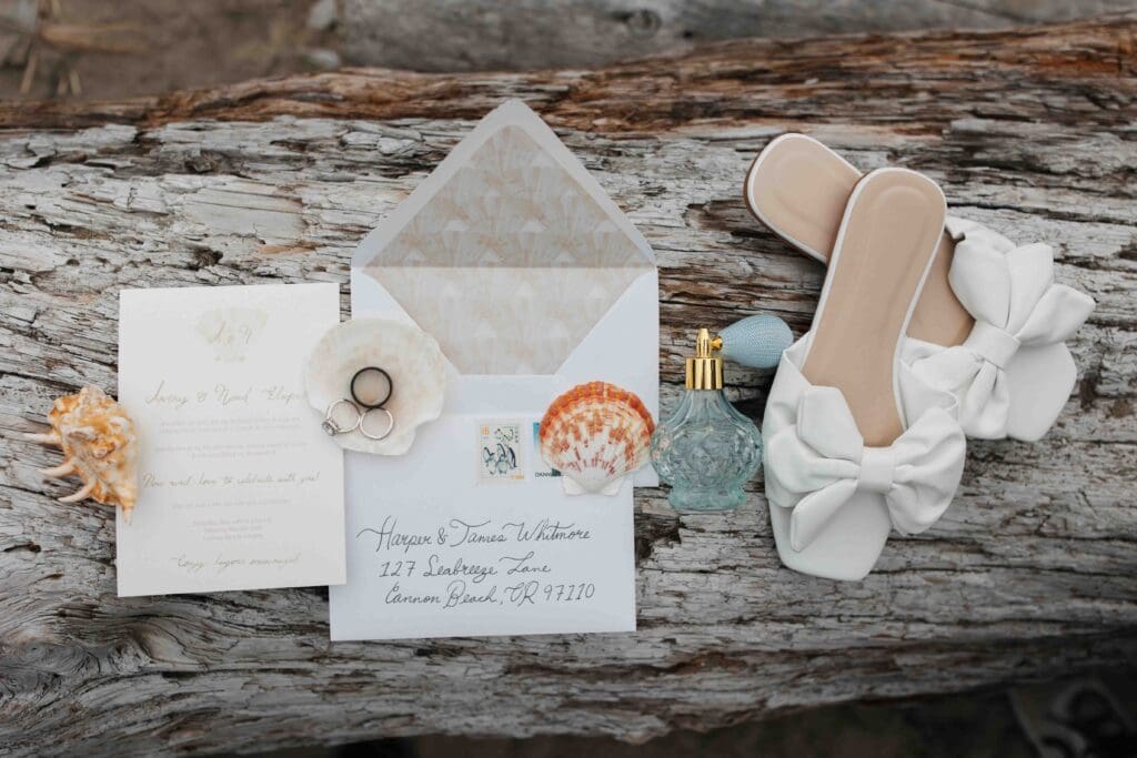 elopement invites that are ocean themed with shoes and perfume